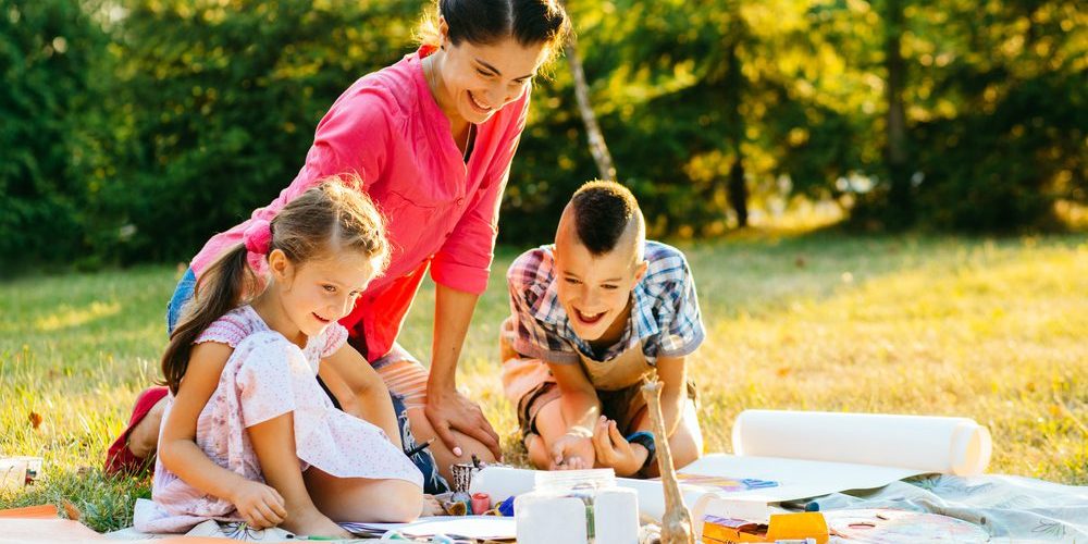 Happy,Mother,And,Two,Kids,Are,Painting,In,The,Park. Campsite Crafts for Kids: Unleashing Creativity with Nature's Treasures