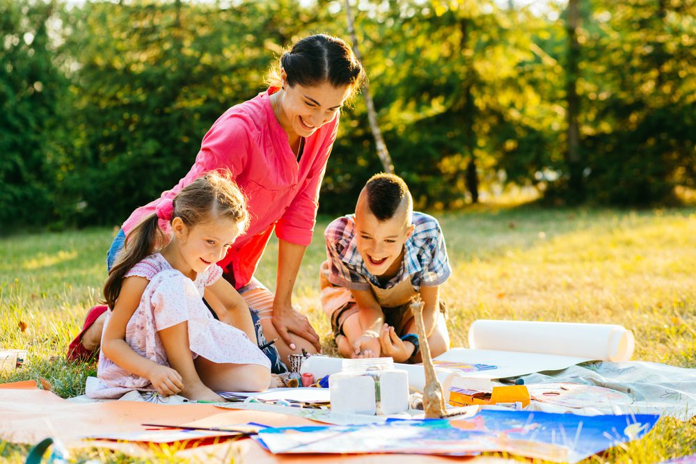 Happy,Mother,And,Two,Kids,Are,Painting,In,The,Park. Campsite Crafts for Kids: Unleashing Creativity with Nature's Treasures